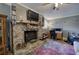 Living room featuring a stone fireplace, wood floors and neutral decor at 1240 Evans Cook Rd, Canton, GA 30115