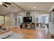 Open-concept living room with hardwood floors, dining area, and ample natural light at 1240 Evans Cook Rd, Canton, GA 30115