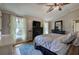 Comfortable main bedroom with a ceiling fan, dark furniture, and natural light, creating a peaceful retreat at 1240 Evans Cook Rd, Canton, GA 30115