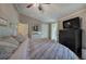 Bedroom with a ceiling fan, wooden floors, a view into another room, and a dark dresser at 1240 Evans Cook Rd, Canton, GA 30115