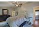 Relaxing main bedroom featuring a decorative headboard, soft lighting, and serene decor, perfect for unwinding at 1240 Evans Cook Rd, Canton, GA 30115