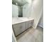 Bathroom featuring dual sinks, white countertops, gray cabinets, and modern fixtures at 1393 Vayda Ct, Marietta, GA 30066