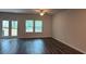 Well-lit living room featuring hardwood floors and access to the backyard at 1393 Vayda Ct, Marietta, GA 30066