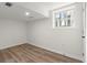 Finished basement with a window, white walls, and laminate flooring at 1937 Joseph Ct, Decatur, GA 30032