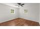 Bedroom features hardwood floors, two windows, a ceiling fan, and neutral paint at 1937 Joseph Ct, Decatur, GA 30032