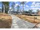 Long driveway leading up to a charming white brick home featuring a convenient carport and a well-kept front yard at 1937 Joseph Ct, Decatur, GA 30032