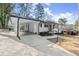 Eye-catching home with a pristine white exterior, a carport, and a neatly landscaped yard, creating a welcoming entrance at 1937 Joseph Ct, Decatur, GA 30032