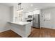 Well-designed kitchen with white cabinetry, stainless steel appliances, and a breakfast bar, offering style and functionality at 1937 Joseph Ct, Decatur, GA 30032