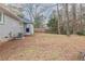 Large, grassy backyard with a partial fence and mature trees around the perimeter at 2303 Pinewood Dr, Decatur, GA 30032