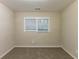 Bedroom features neutral walls, window, and neutral carpet at 2303 Pinewood Dr, Decatur, GA 30032