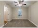 Neutral bedroom with carpet, window, and door to hallway at 2303 Pinewood Dr, Decatur, GA 30032