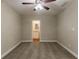 Carpeted bedroom with neutral walls, ceiling fan, and view to en suite bathroom at 2303 Pinewood Dr, Decatur, GA 30032