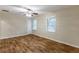 Spacious bedroom with a modern ceiling fan, natural lighting, neutral walls, and beautiful wood-look flooring at 2303 Pinewood Dr, Decatur, GA 30032