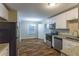 Modern kitchen with stainless steel appliances, granite counters, white cabinets, and hardwood flooring at 2303 Pinewood Dr, Decatur, GA 30032