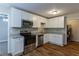 Bright kitchen with white cabinets, stainless steel appliances, granite countertops, and hardwood floors at 2303 Pinewood Dr, Decatur, GA 30032