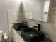 Modern bathroom featuring double sinks, matte black faucets, and a sleek vanity with marble-style backsplash at 3630 High Point Sw Ln, Atlanta, GA 30331