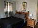 Cozy bedroom with wooden furniture, dark bedding, and natural light at 3630 High Point Sw Ln, Atlanta, GA 30331