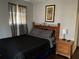 Bedroom with wood headboard, nightstand, and decorative wall art at 3630 High Point Sw Ln, Atlanta, GA 30331