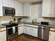 Efficient kitchen with stainless steel appliances, granite countertops, and tiled backsplash at 3630 High Point Sw Ln, Atlanta, GA 30331
