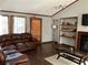 Spacious living room boasts hardwood floors, a leather sofa, built in shelving, and natural light at 3630 High Point Sw Ln, Atlanta, GA 30331