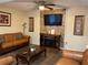 Inviting living room featuring stylish leather furniture, brick accent wall and a fireplace at 3630 High Point Sw Ln, Atlanta, GA 30331