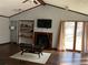 Cozy living room with a fireplace, vaulted ceiling, and natural light, creating a relaxing atmosphere at 3630 High Point Sw Ln, Atlanta, GA 30331