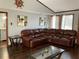 Inviting living room featuring a large leather sectional, dark trim, hardwood floors, and stylish decor at 3630 High Point Sw Ln, Atlanta, GA 30331