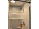 Clean, white shower features a built-in seat and modern fixtures, offering a convenient and comfortable bathing experience at 3630 High Point Sw Ln, Atlanta, GA 30331