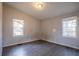 This bedroom has wood floors and two windows that let in natural light at 546 W Sherwood Dr, Riverdale, GA 30274