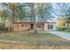 Charming single-story home with brick facade, large windows, and mature trees on a sunny day at 546 W Sherwood Dr, Riverdale, GA 30274