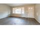 Living room with hard surface flooring, a large window with a damaged blind, and a front door at 546 W Sherwood Dr, Riverdale, GA 30274