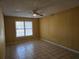 Tranquil bedroom with tile flooring, a ceiling fan, and a large window offering natural light at 634 S Jeff Davis S Dr, Fayetteville, GA 30215