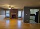 Open-concept living area showcasing hardwood floors, a fireplace, and a view into the adjacent kitchen at 634 S Jeff Davis S Dr, Fayetteville, GA 30215