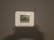 Image of a Honeywell Home thermostat on the wall, displaying current temperature at 634 S Jeff Davis S Dr, Fayetteville, GA 30215