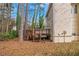 This backyard features a small elevated deck perfect for outdoor relaxation and entertainment at 1458 Walnut Log Pl, Austell, GA 30168