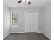 This bedroom features neutral walls, carpet flooring, a ceiling fan, and a window with blinds at 1458 Walnut Log Pl, Austell, GA 30168