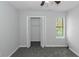 This bedroom features neutral walls, carpet flooring, a ceiling fan, and a closet with blinds at 1458 Walnut Log Pl, Austell, GA 30168