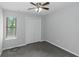 This bedroom features neutral walls, carpet flooring, a ceiling fan, and a window with blinds at 1458 Walnut Log Pl, Austell, GA 30168