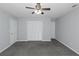 This bedroom features plush carpeting, neutral walls, and a large closet at 1458 Walnut Log Pl, Austell, GA 30168