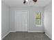 This bedroom features neutral walls, carpet flooring, a ceiling fan, and a window with blinds at 1458 Walnut Log Pl, Austell, GA 30168