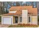 This exterior elevation shows a home with an attached garage, yard, and mature landscaping at 1458 Walnut Log Pl, Austell, GA 30168