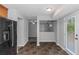 Open kitchen area leading to additional rooms with stainless steel refrigerator and neutral walls at 1458 Walnut Log Pl, Austell, GA 30168