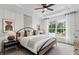 Serene bedroom with neutral tones, a tray ceiling, a large window, and comfortable furnishings at 2537 Astaire Ct, Atlanta, GA 30318