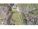A bird's-eye view of a home surrounded by lush forest and a long driveway at 210 Cowan Se Rd, Conyers, GA 30094