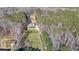 Serene aerial view of a home nestled among mature trees and sprawling landscape at 210 Cowan Se Rd, Conyers, GA 30094
