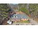 Aerial view of a single-story home with a spacious driveway and lush greenery at 210 Cowan Se Rd, Conyers, GA 30094