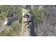 An aerial perspective of two houses, adjacent to each other and surrounded by dense woodland at 210 Cowan Se Rd, Conyers, GA 30094