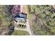 Overhead view of a home, with a circular driveway and a partially wooded lot at 210 Cowan Se Rd, Conyers, GA 30094