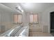 Bathroom featuring double sinks, soaking tub, and tiled floors at 210 Cowan Se Rd, Conyers, GA 30094