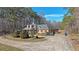 Spacious single-story home with a circular driveway and surrounded by mature trees at 210 Cowan Se Rd, Conyers, GA 30094